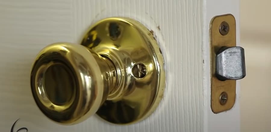 Why is the door latch stuck in the locked position